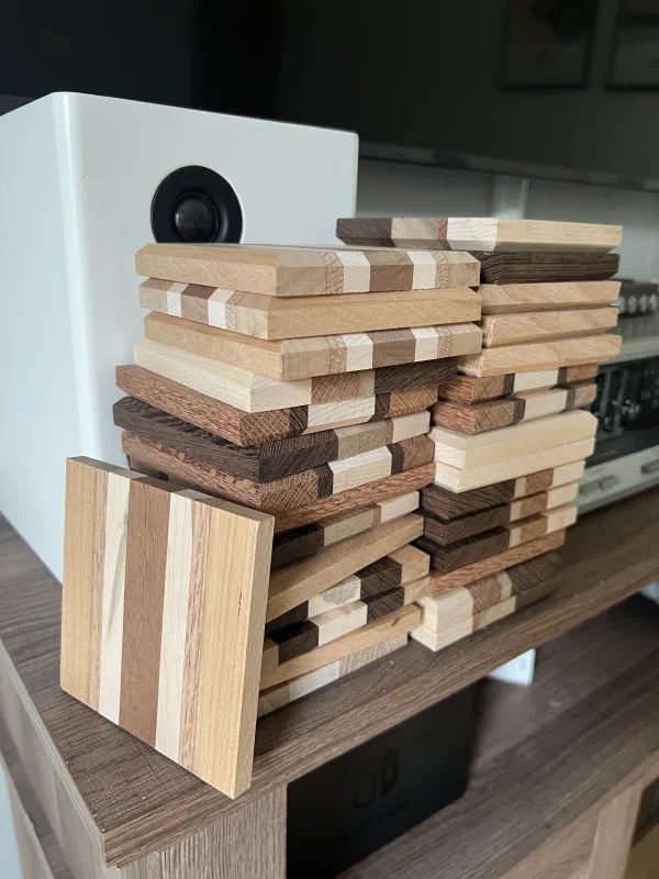A stack of several unfinished wood drink coasters